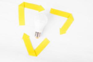 recycle mark with penergy-saving light bulb inside on white background. zero waste concept photo
