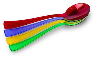 Colored plastic spoons on white photo
