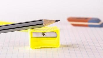 The pencils with pencil sharpener and eraser isolated on white background photo