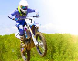 The blurry image of motorcycle rider during motocross race photo