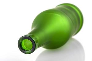 empty green glass bottle isolated on white background photo