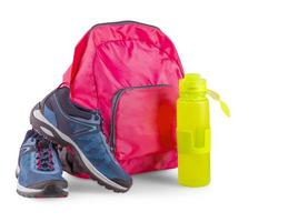 the Pair of blue women's sneakers in pink backpack and sports bottle for a water on white photo