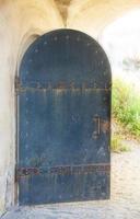 old opened metal door in a medieval castle close up photo