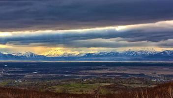 snowy mountains and storm clouds autumn on Kamchatka photo