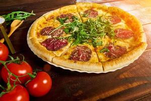 sliced pizza with beef and greens close-u photo