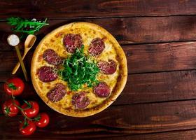 Pizza with beef on a wooden table. beautiful background photo