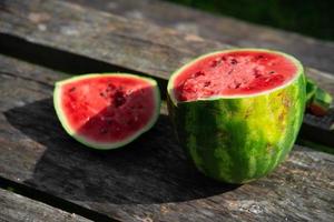 watermelon cut into two parts at a picnic photo