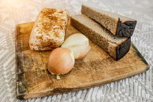 homemade lard, bread and onions on the cutting Board. National food. photo