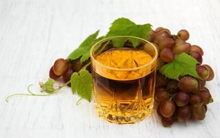 Glass with wine and white grape photo