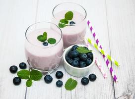 Glasses with blueberry yogurt on a table photo