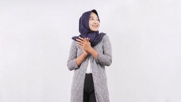 asian woman in hijab smiling while clapping isolated on white background photo