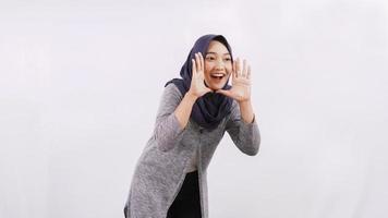 young asian woman shouting gesture isolated white background photo