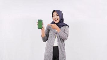 asian woman showing smartphone screen isolated on white background photo