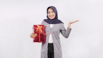 asian girl carrying a gift showing side blank isolated on white background photo