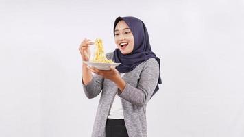 asian girl happily enjoying noodles isolated on white background photo