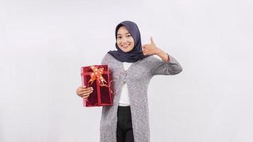 asian girl bringing gift gesture ok isolated on white background photo