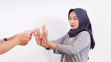 asian girl refuses bribe isolated on white background photo