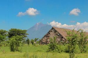 Outside the Tobacco house or Los Tembakau or Los Mbako, warehouse for storing and drying harvested tobacco leaves in Klaten Regency, Central Java, Indonesia with Merapi Mountain Background photo