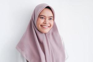 Young Asian Islam woman wearing headscarf with smile in face to camera. Indonesian woman. Beauty concept isolated on gray background photo