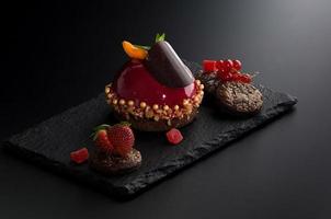 cake with berries on a dark background photo