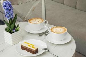 cake in a plate and a cup on the table photo