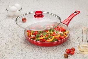 frying pan with sliced vegetables photo