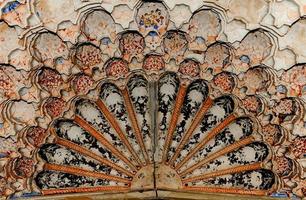 Elements of ancient architecture of Central Asia. Ceiling in the form of a dome in a traditional ancient Asian mosaic photo