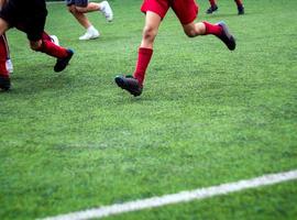 The footballers are competing in color sports of elementary school photo