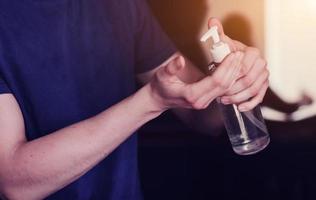 man with alcohol gel or antibacterial soap photo