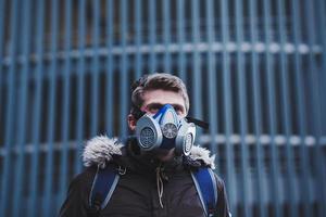 Portrait of a sick man wearing mask in city photo