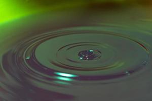 Radioactive liquid in a barrel. Toxic hazardous waste. Circles on the surface from shaking in the tank. Flammable substances. photo