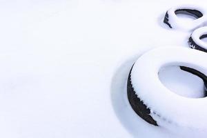 Tires covered with snow. Circles on a white field. Winter theme. photo