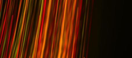 Multi-colored rays on a dark background. Abstraction. Drawing with light. Photoelectric effect. photo