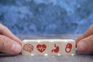 Stacked wooden blocks with medical iconography, health care, and health insurance concepts. photo