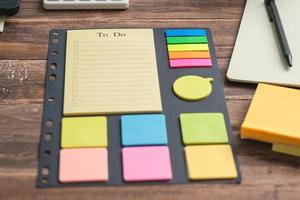 to do list planner on wooden office desk photo