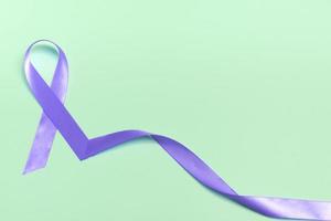 Closeup purple ribbon on a blue background with copy space. World epilepsy day.Banner photo