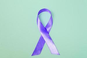 Closeup purple ribbon on a blue background with copy space. World epilepsy day.Banner photo