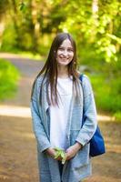 Female portrait of a young woman in the park on the path photo