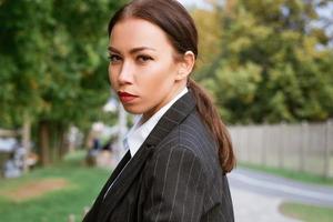 Woman's portrait on the street of the city. Business young woman in suit photo