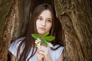 mujer joven sobre un fondo de árbol foto