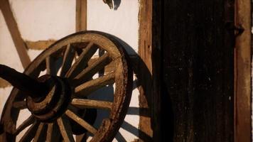 old wood wheel and black door at white house photo