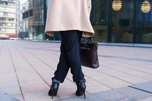 female leg of a business woman on the street near the office building photo