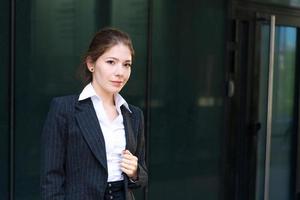 Young business woman in suit near office building photo