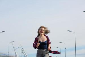 Happy woman running down the street with lanterns on the fne of the sky photo