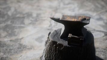 Old anvil attached to a stump photo