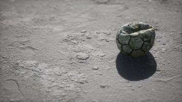 Old soccer ball the cement floor photo