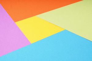 multicolor paper background with 5 different colors in triangle and rhombus shapes photo