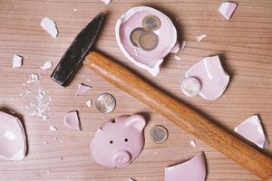 broken Piggy bank smashed into pieces with hammer and small chan photo