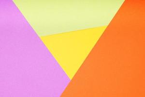 multicolor paper background with 4 different colors in triangle and rhombus shapes photo