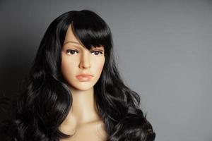shop window mannequin or display dummy head with brunette wig and naturalistic face photo